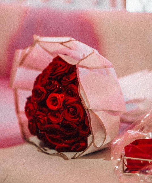 Bouquet of red roses in pink paper