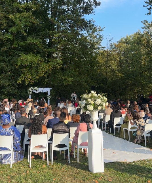 Outdoor ceremony, flowered arch and white aisle